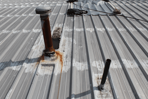 Damaged metal roof in need of retrofitting upgrade.